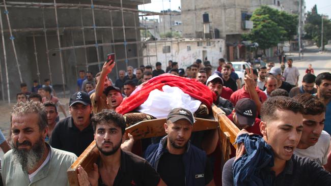 Relatives and friends mourn a young Palestinian man on October 08, 2023 in Gaza City, Gaza. Picture: Ahmad Hasaballah/Getty Images