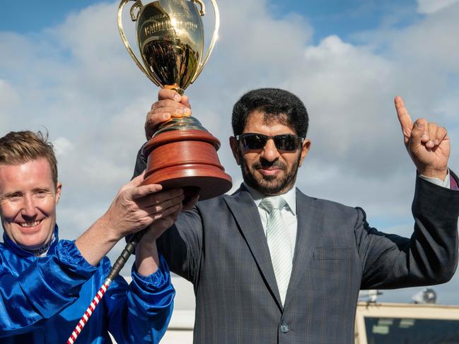 Winning jockey Pat Cosgrave and trainer Saeed Bin Suroor with the trophy. Picture Jay Town