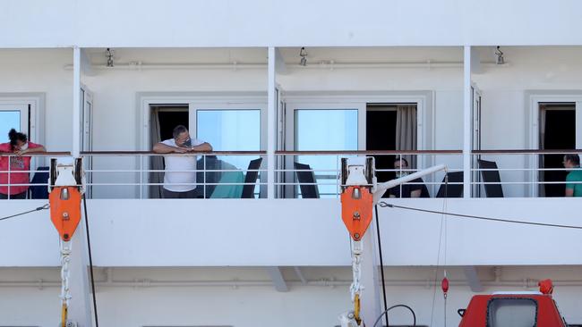 Crew members from the cruise ship Artania are seen isolating in their cabins. Picture: Richard Wainwright/AAP