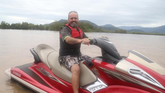 Boe Willcox on a jetski he used to ferry dozens of people in and out of Holloways Beach. Picture: Peter Carruthers