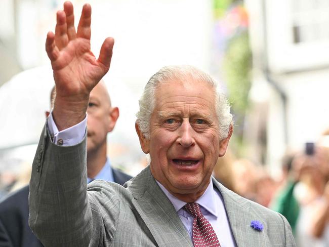 Britain's King Charles III waves during a visit to St Ives Harbour in Cornwall, southwest England, on July 13, 2023. (Photo by Finnbarr Webster / POOL / AFP)