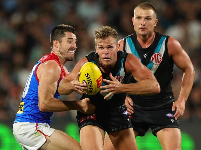 ADELAIDE, AUSTRALIA - MARCH 30: Dan Houston of the Power and Alex Neal-Bullen of the Demons and Ollie Wines of the Power during the 2024 AFL Round 03 match between the Port Adelaide Power and the Melbourne Demons at Adelaide Oval on March 30, 2024 in Adelaide, Australia. (Photo by Sarah Reed/AFL Photos via Getty Images)