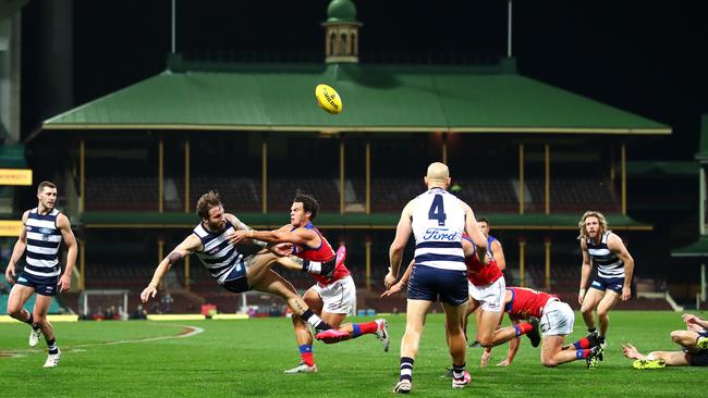 Geelong’s Zach Tuohy gets a kick away under pressure against Brisbane in a ‘home’ match in front of a sparse crowd at the SCG. Picture: Getty Images