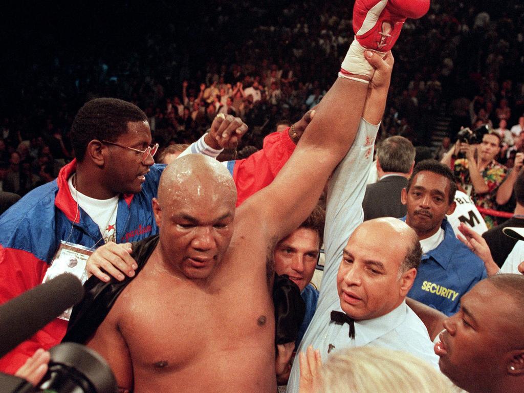 George Foreman celebrates after knocking out Michael Moorer in the tenth round of their scheduled 12 round IBF/WBA heavyweight title fight, on November 5, 1994. Picture: AFP