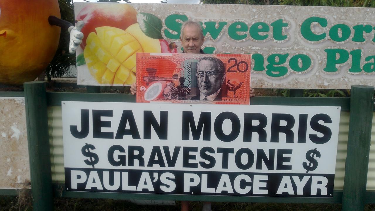 Henry Petersen with the sign on his fence for Jean Morris' gravestone fundraiser.