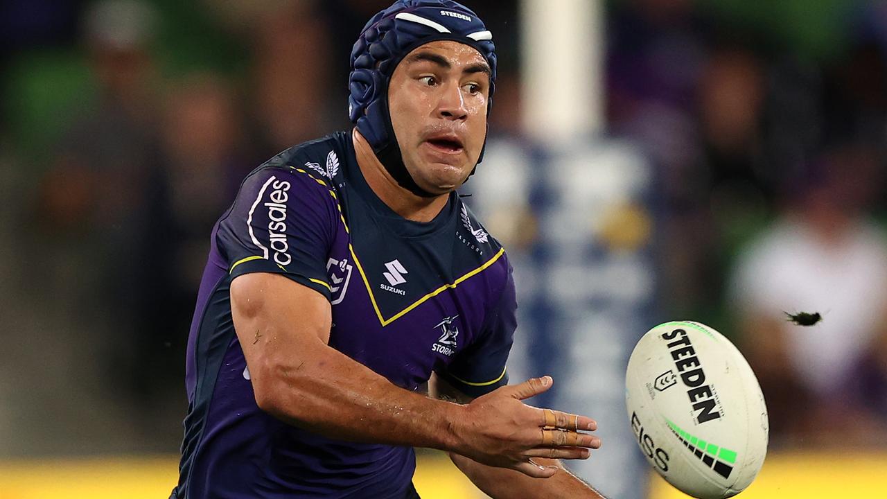 MELBOURNE, AUSTRALIA - APRIL 30: Jahrome Hughes of the Storm offloads the ball during the round eight NRL match between the Melbourne Storm and the Cronulla Sharks at AAMI Park on April 30, 2021, in Melbourne, Australia. (Photo by Robert Cianflone/Getty Images)