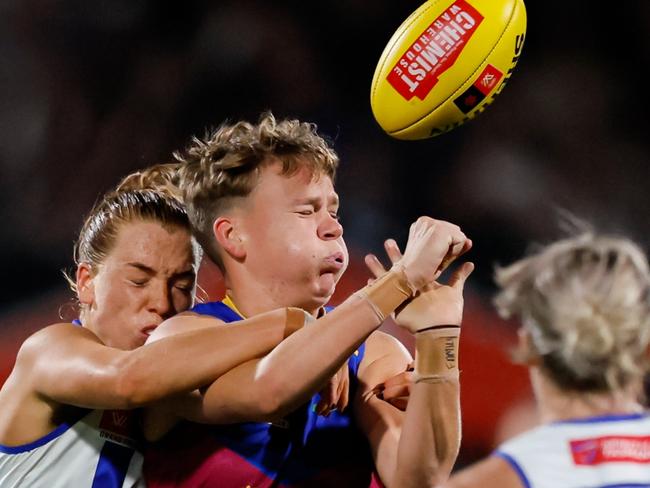 MELBOURNE, AUSTRALIA - NOVEMBER 30: Dakota Davidson of the Lions gets a handpass off whilst being tackled by Mia King of the Kangaroos during the 2024 AFLW Grand Final match between the North Melbourne Tasmanian Kangaroos and the Brisbane Lions at IKON Park on November 30, 2024 in Melbourne, Australia. (Photo by Dylan Burns/AFL Photos via Getty Images)