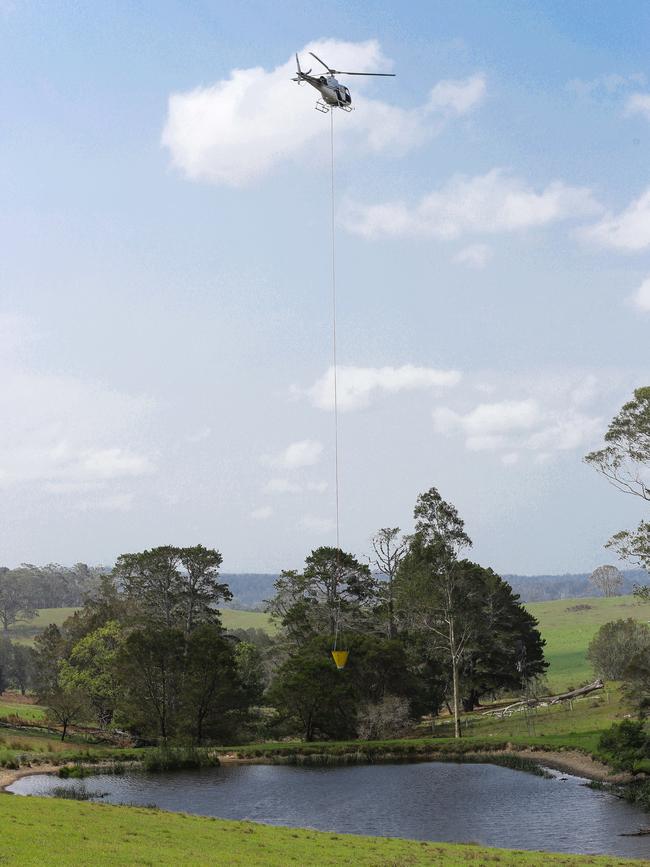 A helicopter scoops water from the Bodalla Dairy Cheese Factory dam on January 25. Picture: Gaye Gerard