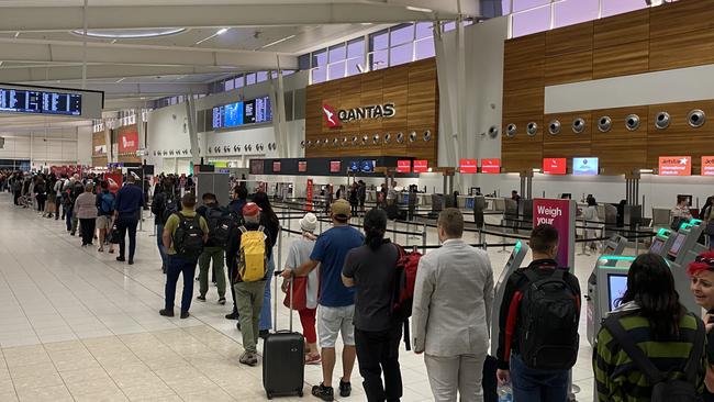 Adelaide Airport at 5.30am this morning. Lines for security at the airport are out the doors, around the barrier. Picture: Kathryn Bermingham