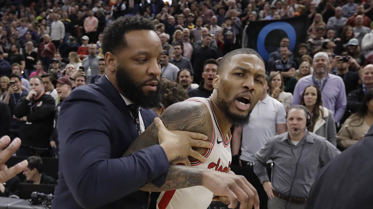 Portland Trail Blazers guard Damian Lillard had to be held back.