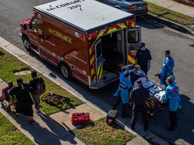 Los Angeles paramedics load a potential Covid-19 patient into an ambulance. Picture: AFP.