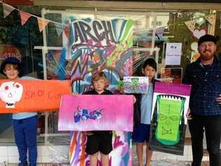 Finn, Levi and Padi create street art with artist Justin Livingstone at the ARCH community Arts Club on Carrington st in June.