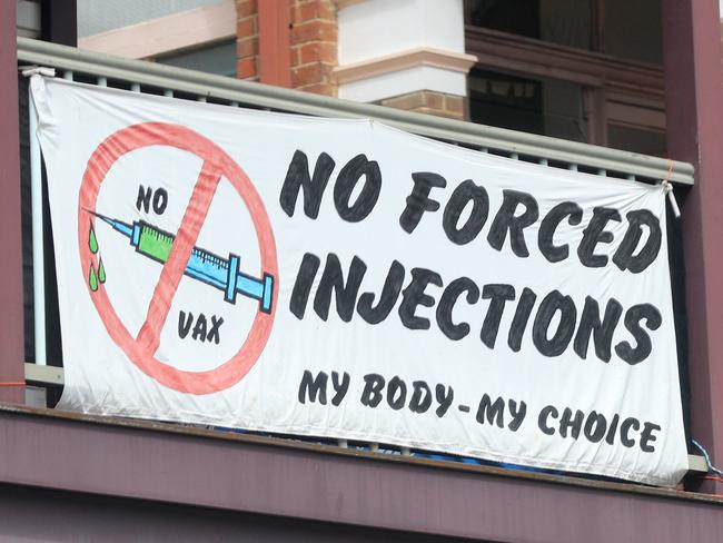 MULLUMBIMBY , AUSTRALIA - NewsWire Photos April 01, 2021: Anti Vaxxers hang protest signs 'NO FORCED INJECTIONS'  in the Main Street of Mullumbimby in reference to the Covid-19 roll out of a vaccination..Picture: NCA NewsWire / Scott Powick