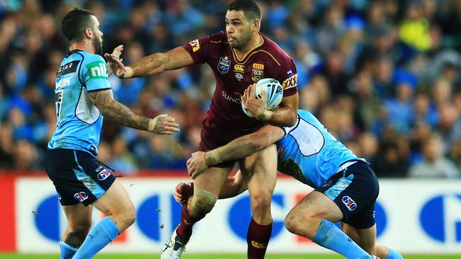 Greg Inglis fends off Adam Reynolds during State of Origin I. Picture: Mark Evans