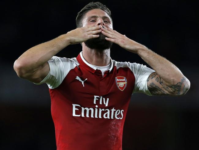 Arsenal's French striker Olivier Giroud gestures to supporters on the pitch after the English Premier League football match between Arsenal and Leicester City at the Emirates Stadium in London on August 11, 2017. Arsenal won the game 4-3. / AFP PHOTO / Ian KINGTON / RESTRICTED TO EDITORIAL USE. No use with unauthorized audio, video, data, fixture lists, club/league logos or 'live' services. Online in-match use limited to 75 images, no video emulation. No use in betting, games or single club/league/player publications.  /