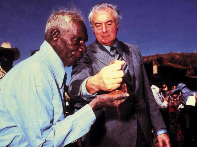 Historic moment ... Gough Whitlam pours sand into hand of Vincent Lingiari during the 1975 handover of traditional Gurindji land at Wave Hill. Picture: News Corp Australia.