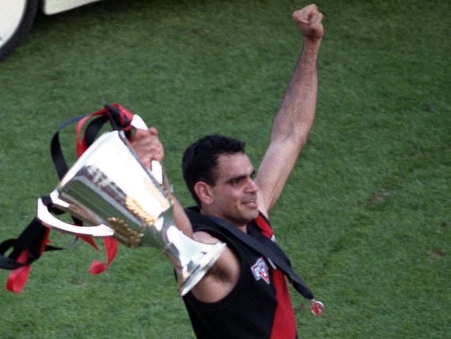 Territory AFL legend Michael Long holds the premiership cup aloft after Essendon defeated Carlton in the 1993 Grand Final at the MCG. Long was named the Norm Smith medallist