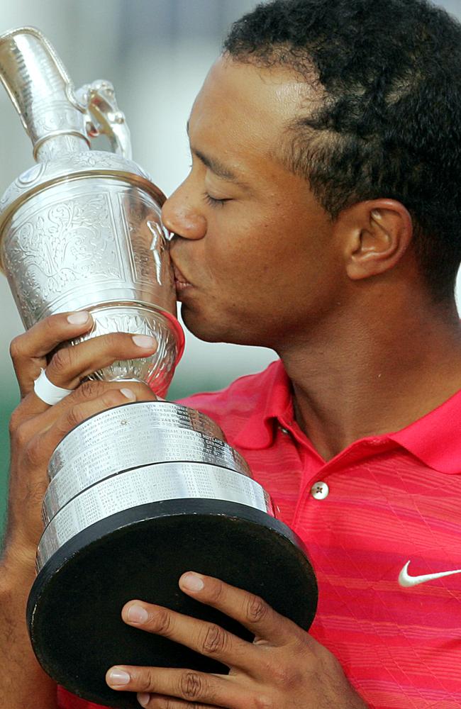FILE - This July 23, 2006, file photo shows Tiger Woods of the United States, kissing the British Open Golf Championship trophy at the Royal Liverpool Golf Course in Hoylake, England. Royal Liverpool will host the 2014 British Open, the 12th time it will stage golf's oldest major. Tiger Woods won the tournament the last time it was played on the links course at Hoylake on the northwest English coast in 2006, becoming the first back-to-back winner since Tom Watson in 1983.(AP Photo/Matt Dunham, File)