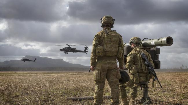 Members of 16th Regiment armed with their RBS-70 watch over the battle field as two US Army Apache Attack helicopters demonstrate their capability during Talisman Sabre 2019 exercises at Shoalwater Bay, Queensland. Picture: AAP