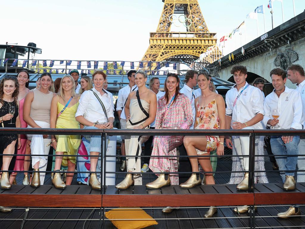 Medal-winning Australian athletes wear gold boots on the Gina Rinehart-hosted hosted boat cruise on the Seine River in Paris after completing competition. Picture: Adam Head