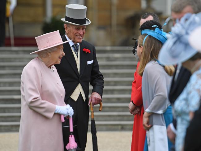 Britain’s Queen Elizabeth II and Britain’s Prince Philip, Duke of Edinburgh greet guests at a garden party at Buckingham Palace in London on May 16, 2017. Picture: AFP