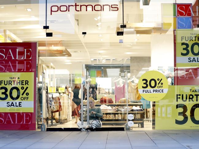 A staff member chains the door of Portmans in SydneyÕs CBD on Thursday 26 March 2020. Premiere Investments, who owns Portmans, is shutting all it's stores from 6pm tonight. Picture: Nikki Short