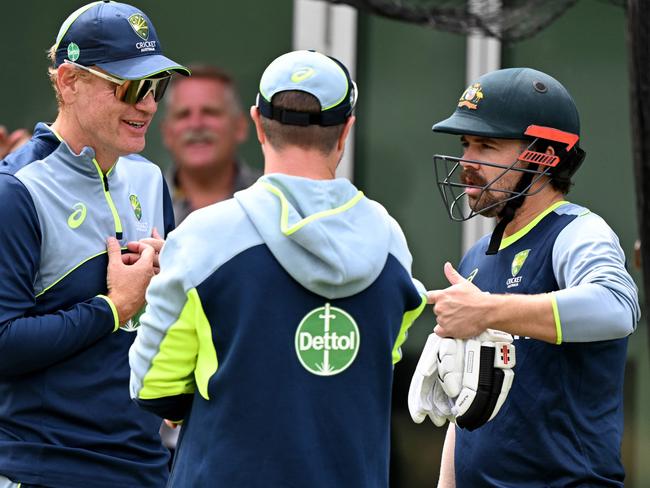 Travis Head (right) talks to Australian coach Andrew McDonald (left) and physio Nick Jones (centre) after his brief net session at the MCG on Christmas Eve. Picture: William West / AFP