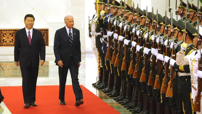 Chinese Vice President Xi Jinping escorts then Vice President Joe Biden past Chinese honour guards.