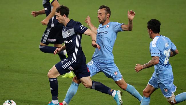 Robbie Kruse is fouled by Florin Berenguer during Friday’s Melbourne derby.