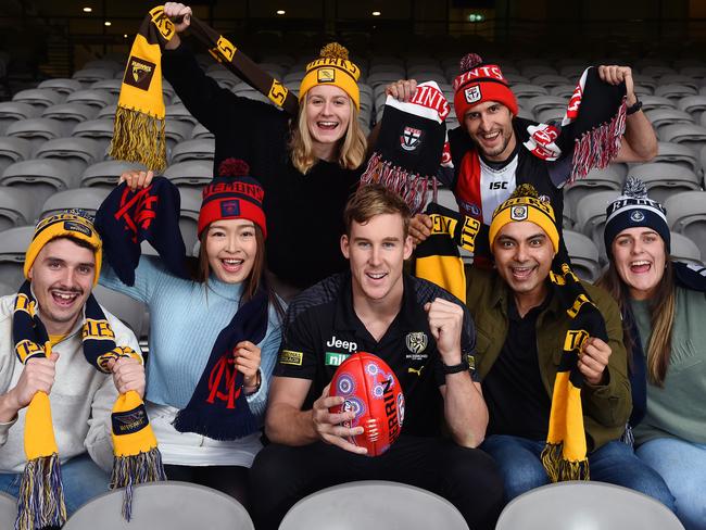 AFL members will be allowed to sit with each other in preferred seats again next to family and friends. (L-R) James DÃElia, Elena Gao, Hayleigh Sharman (back), Richmond star Tom Lynch,  Iain Reitman (back), Sudip Chakraborty and Bronte Van Eeken at Marvel Stadium. Picture: Josie Hayden