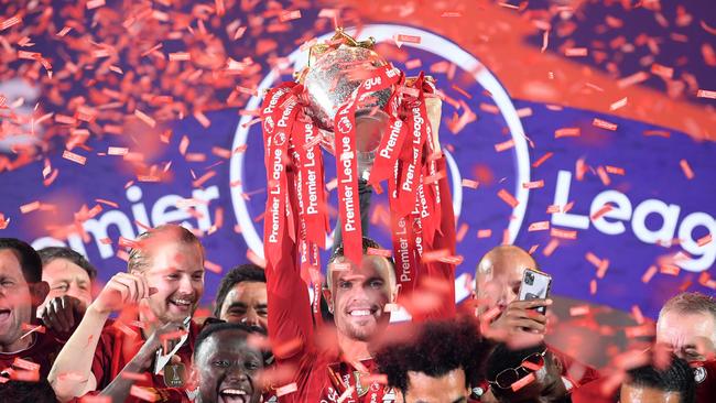 Jordan Henderson lifts the Premier League trophy following Liverpool’s win over Chelsea at Anfield. Picture: Getty Images