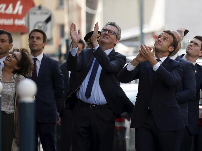 French President Emmanuel Macron, right, applauds residents after visiting a medical centre in Pantin, near Paris. Picture: AP