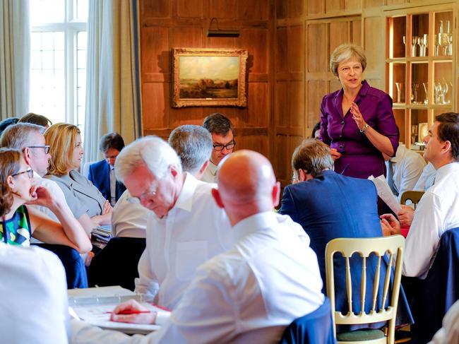 In this handout image taken and released on July 6, 2018, by the Prime Minister's Press Office, Britain's Prime Minister Theresa May speaks to members of her cabinet at the Prime Minister's rural country residence, Chequers, west of London. British Prime Minister Theresa May sought Friday to finally unite her warring ministers behind a Brexit plan and unblock negotiations with the European Union, amid warnings she is running out of time to get a deal. / AFP PHOTO / CROWN COPYRIGHT 2018 / Joel ROUSE / RESTRICTED TO EDITORIAL USE - MANDATORY CREDIT "AFP PHOTO / CROWN COPYRIGHT (JOEL ROUSE)" - NO MARKETING NO ADVERTISING CAMPAIGNS - DISTRIBUTED AS A SERVICE TO CLIENTS