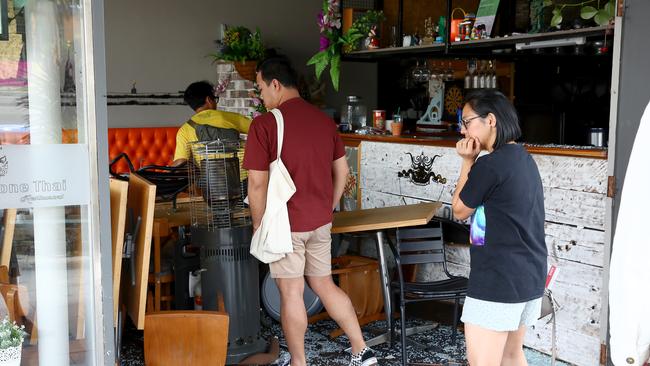 The owners of the restaurant where Lockrey’s car smashed into inspect the damage. Picture: Toby Zerna