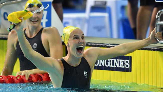 Bronte Campbell of Australia celebrates, as Cate Campbell of Australia looks on, after winning the Women’s 100m Freestyle Final.