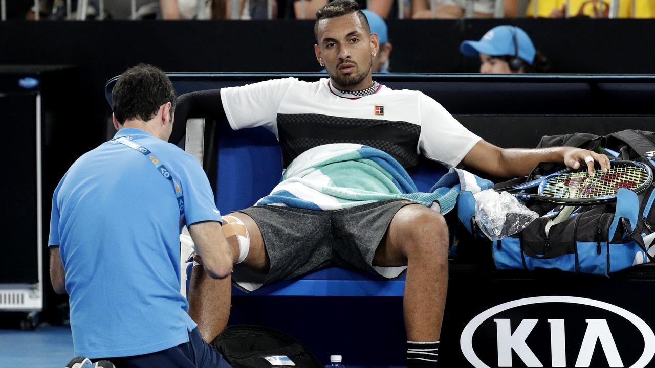Australia's Nick Kyrgios has his knee attended to. Photo: AP Photo/Aaron Favila