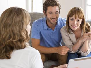 A couple sorting out their home loan with their mortgage broker. Picture: iStock.