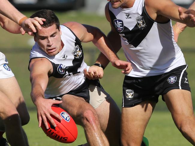 Brandon Chadwick (left) plays at the ball shielded by Andrew Boston. Picture: Glenn Ham pson.