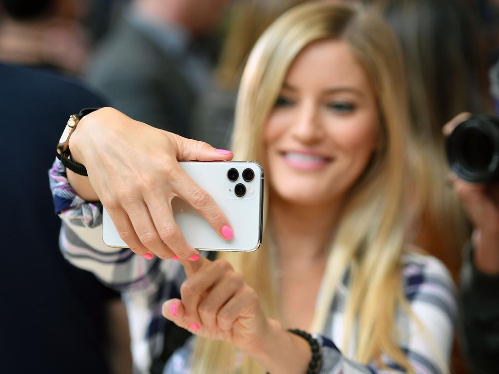 A woman tries out a new Apple 11 Pro during an Apple product launch event at Apple's headquarters in Cupertino, California. Picture: AFP