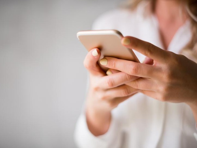 Close up of a woman using her smartphone indoors. generic. istock