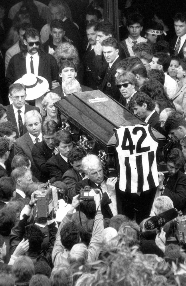 Collingwood star Darren Millane’s jumper draped over his coffin at his packed funeral in 1991 is an image most Pies fans, alive at the time, will never forget. Killed in a drunken car smash at the height of his football career, Millane’s car ran into the back of a truck on Queens Road, Albert Park in October 1991. His blood alcohol content was 0.322, more than six times the legal limit. Millane, the man frequently touted as Collingwood’s next captain and seemingly indestructible at the time, had been cut down in his prime, at just 26.