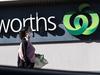 SYDNEY, AUSTRALIA - AUGUST 17: A woman in a surgical mask walks past the entrance to the Woolworths Metro supermarket in North Strathfield on August 17, 2020 in Sydney, Australia. New South Wales remains on high alert as new COVID-19 cases continue to be diagnosed. Customers of the Supermarket are being urged to watch for symptoms after a person who has tested positive for COVID-19 case visited the store over the weekend. The state recorded seven new cases of COVID-19 in the last 24 hours with six locally-acquired and one in hotel quarantine. (Photo by Brook Mitchell/Getty Images)