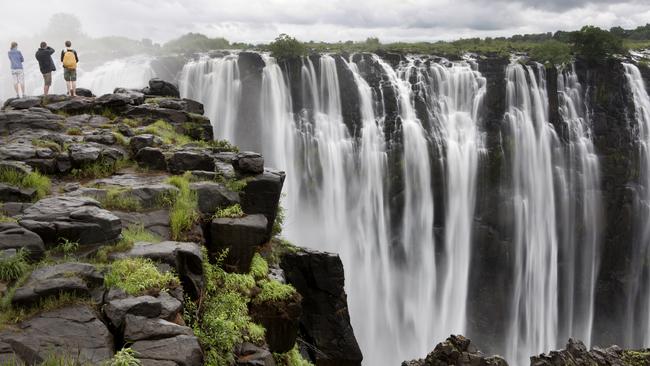 Tourists taking in the grandeur of Victoria Falls.