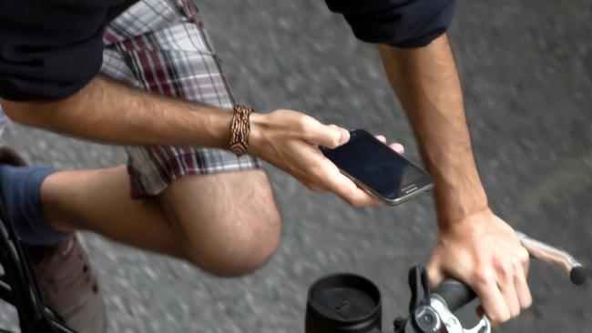 Using your mobile phone while riding a bike can attract huge fines in Queensland.