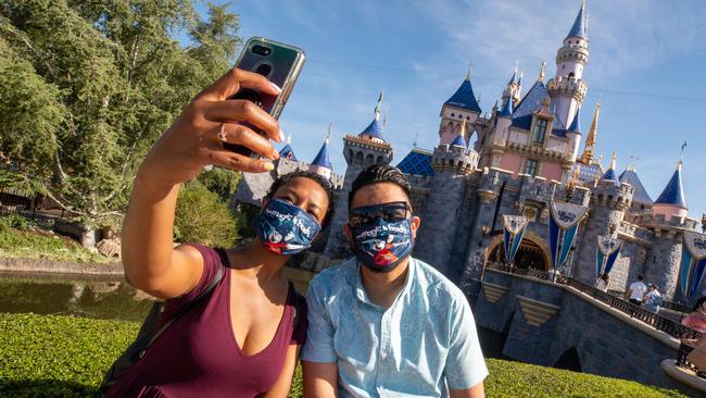 Guests pose in front of Sleeping Beauty Castle at the Disneyland Resort in California. Picture: Getty Images.