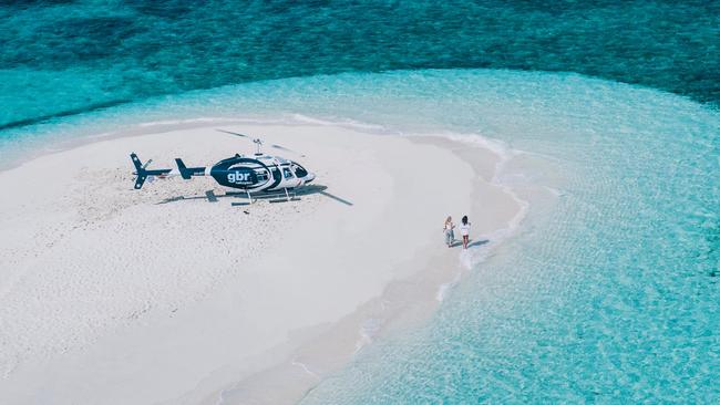 Tourists enjoy a picnic at Vlasoff Cay on the Great Barrier Reef. Picture: Tourism Tropical North Queensland