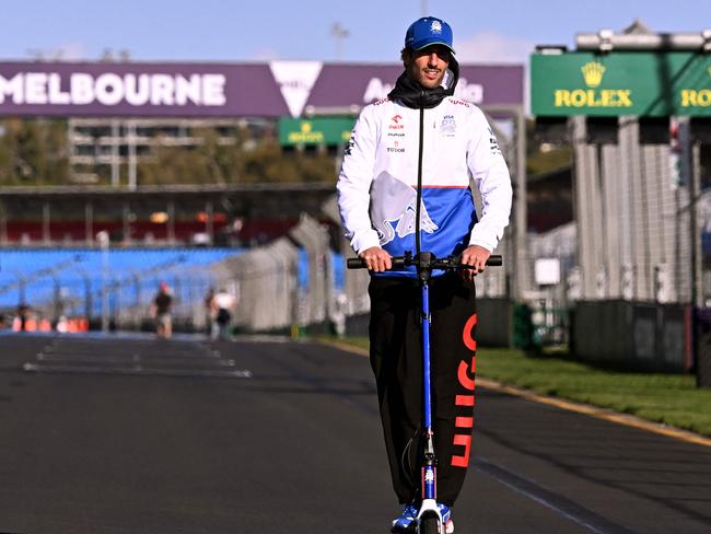 Ricciardo rides his scooter around the Albert Park circuit. Picture: AFP