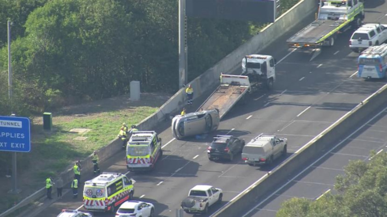 Car left on its side after a car crash involvin three vehicles along the M2 Mwy city-bound on Thursday morning. Photo: 7News