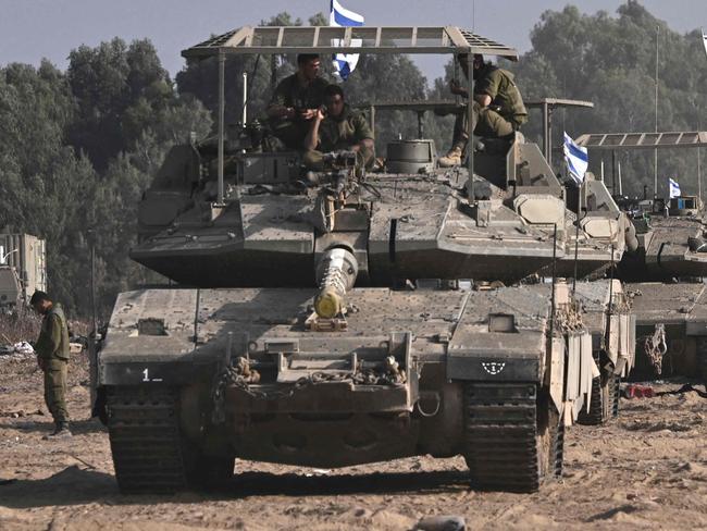 Israeli military armoured vehicles deploy along Israel's border with Gaza on October 24, 2023, amid the ongoing battles between Israel and the Palestinian group Hamas. Thousands of civilians, both Palestinians and Israelis, have died since October 7, 2023, after Palestinian Hamas militants based in the Gaza Strip entered southern Israel in an unprecedented attack triggering a war declared by Israel on Hamas with retaliatory bombings on Gaza. (Photo by Aris MESSINIS / AFP)