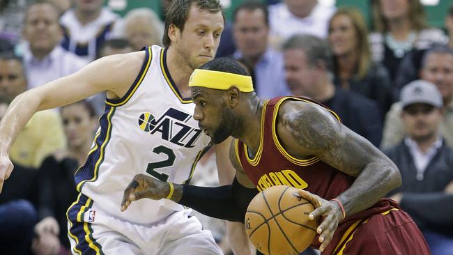 Cleveland Cavaliers' LeBron James (23) drives as Utah Jazz's Joe Ingles (2) defends in the second quarter during an NBA basketball game, Wednesday, Nov. 5, 2014, in Salt Lake City. (AP Photo/Rick Bowmer)